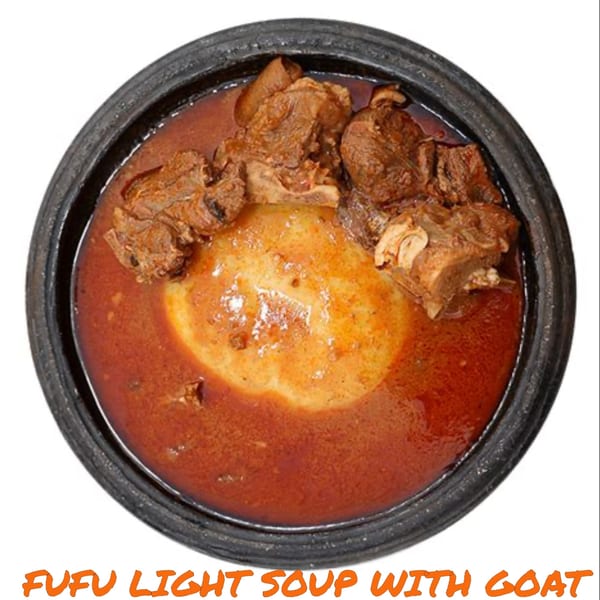 Fufu light soup with goat meat, a traditional African dish, served in a dark bowl.